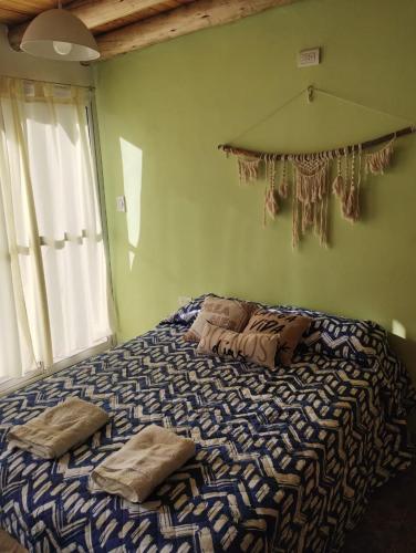 a bed with two pillows on it in a bedroom at Vista los Andes in Cacheuta