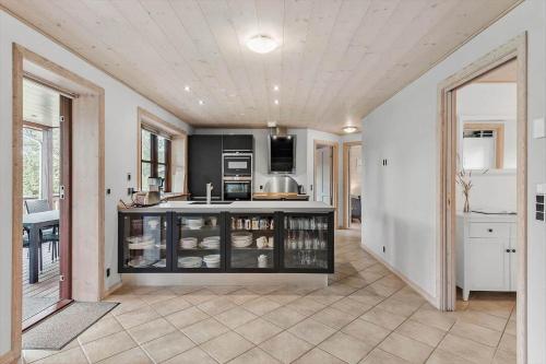 a kitchen with an island in the middle of a room at R962-Rodvig-Skovstumperne-12 in Rødvig