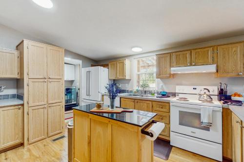 a large kitchen with wooden cabinets and white appliances at The Hideaway on the Lake in Shelton
