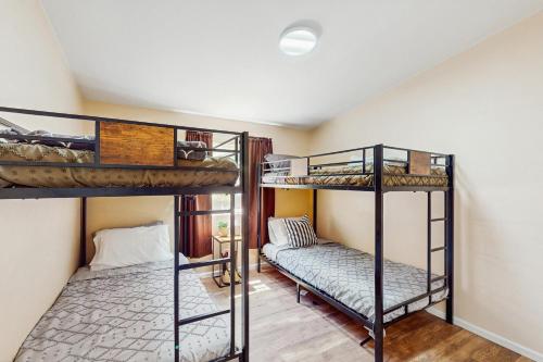 a room with two bunk beds and a couch at The Hideaway on the Lake in Shelton