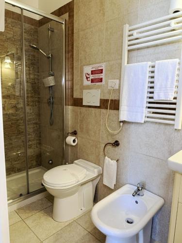 a bathroom with a toilet and a shower and a sink at DONNA LUCREZIA b&b Boutique Hotel Style - relax & business stay in Bisceglie