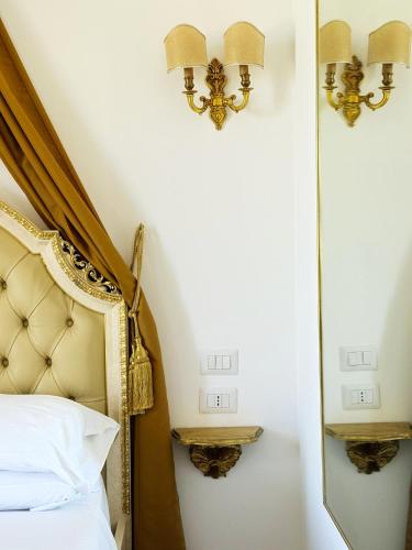 a bedroom with a bed and a mirror at DONNA LUCREZIA b&b Boutique Hotel Style - relax & business stay in Bisceglie