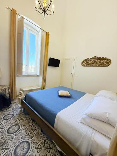 a bedroom with a bed and a window at DONNA LUCREZIA b&b Boutique Hotel Style - relax & business stay in Bisceglie