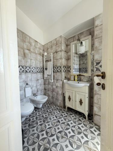 a bathroom with a sink and a toilet at DONNA LUCREZIA b&b Boutique Hotel Style - relax & business stay in Bisceglie
