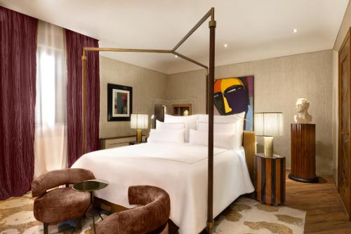 a bedroom with a large bed with a large white bedspread at The James Suite Hotel Firenze 1564 - Small Luxury Hotels of the World in Florence