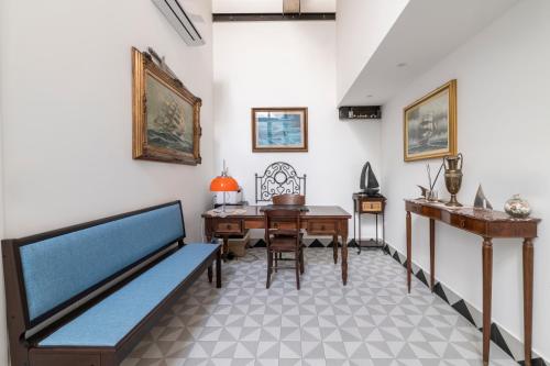 a room with a bed and a desk and a table at Itaca Porto Loft& Rooms in Milazzo