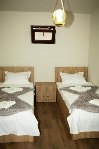 two beds sitting next to each other in a room at NISS House in Akhaltsikhe