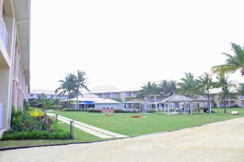a park with palm trees and houses in the background at Holiday Inn Resort Grand Cayman by IHG in George Town
