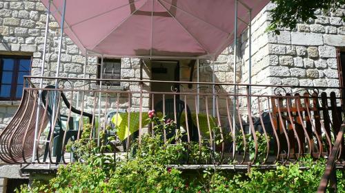 a dog sitting on a porch on a balcony at Les Fabres in Vernon