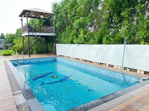 a swimming pool with a gazebo in a house at GoBravo 71- 2BHK Farm with Pool & Garden Sector 150 Noida in Greater Noida