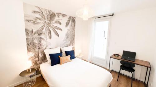 a bedroom with a white bed and a palm tree mural at Albatros in Saint-Nazaire
