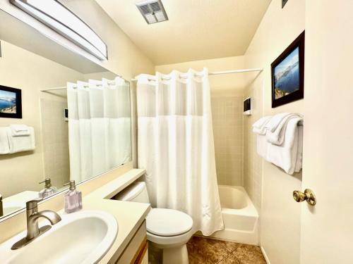 a bathroom with a sink and a toilet and a shower at Sabino Canyon Condo with a Pool and Spa in Tucson