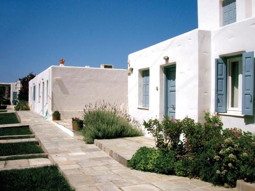 a white house with a pathway in front of it at Antigoni Studios in Skiros