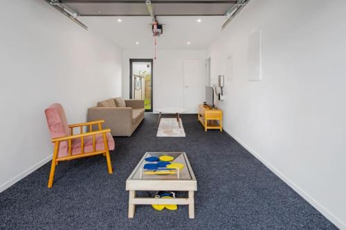 a living room with a couch and a table at Trentham Stylish 2-BR Retreat in Upper Hutt