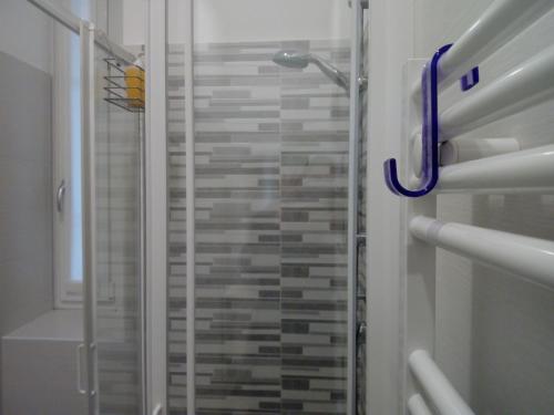 a shower with a glass door in a bathroom at BelSorrisoVarese - Elegance City Residence Private Parking -Reservation Required- in Varese