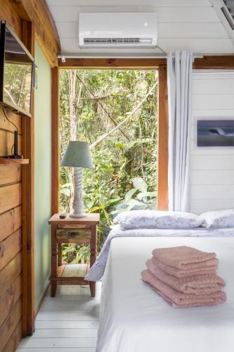 a bedroom with a bed and a window at Micro Casa Gótica in Florianópolis