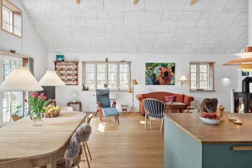 a kitchen and living room with a table and chairs at 2315-Stege-Kongens-Enge-15 in Stege