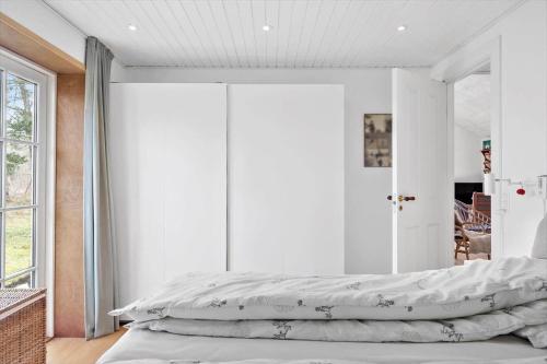 a bedroom with a large bed with white sheets at 2315-Stege-Kongens-Enge-15 in Stege