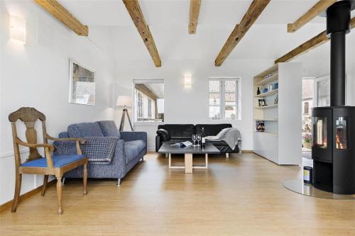 a living room with a blue couch and a table at 6005-Stege-Hjelmvej-15 in Stege