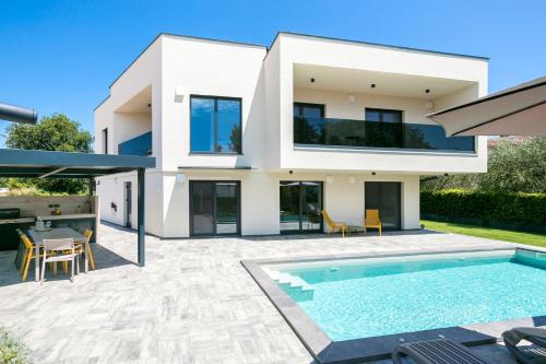 a villa with a swimming pool and a house at Villa Mila - NEW 2025 in Medulin