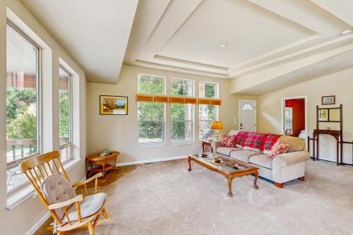 a living room with a couch and a table at Trinity River Retreat in Willow Creek