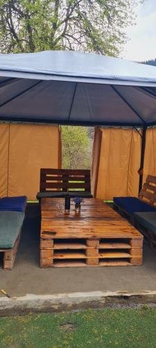 a tent with a bench and chairs under it at LIO in Glola