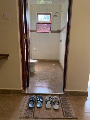 a pair of shoes on a mat in a bathroom at Lantana Comfy in Kakamega