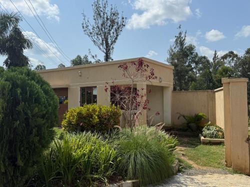 a small house in a yard with a fence at Lantana Comfy in Kakamega