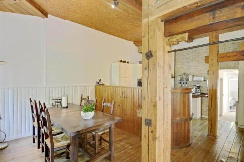 a dining room with a wooden table and a kitchen at 4304-Borre-Klintevej-273 in Borre