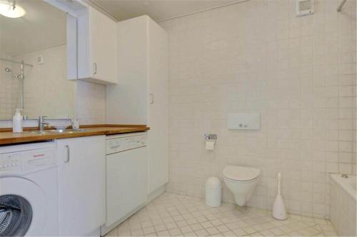 a bathroom with a washing machine and a toilet at 4304-Borre-Klintevej-273 in Borre