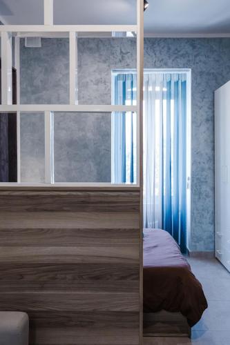 a bedroom with a bed and a large window at Central Apartment in St Julians in St Julian's