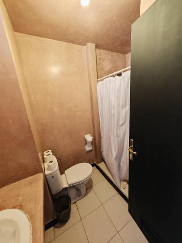 a small bathroom with a toilet and a shower at Agyad Maroc Appart-Hotel in Agadir