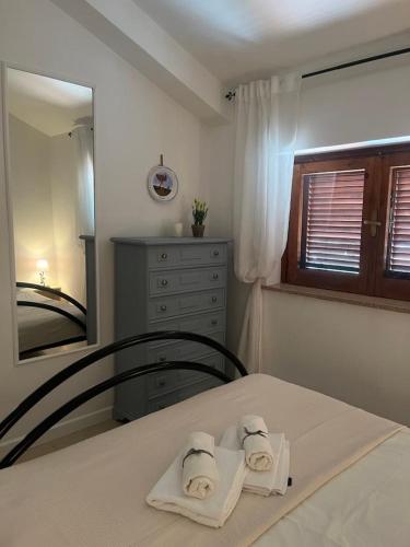 a bedroom with a bed with two towels on it at Bella Vista La Bussola in Scalea
