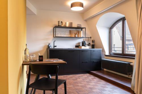 a kitchen with a counter and a table and a window at Studio 9 in Fulda