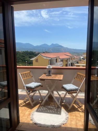 a table and chairs on a balcony with a view at Bella Vista La Bussola in Scalea