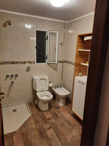 a bathroom with a toilet and a sink at CASA DE CAMPO barrio privado Salta in Cerrillos