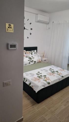 a bedroom with a bed and a clock on the wall at McShane Studio 1 in Dudu