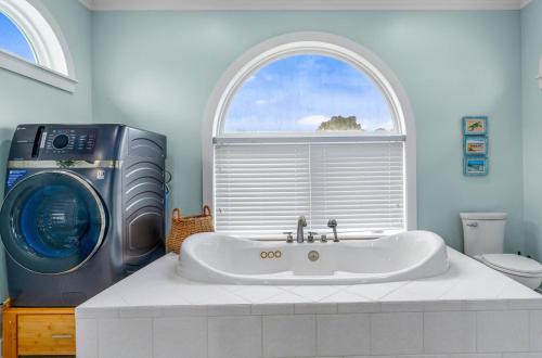 a bathroom with a sink and a washing machine at Sunrise Shores in Carrabelle