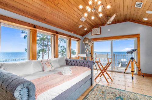 a living room with a couch and views of the ocean at Sunrise Shores in Carrabelle