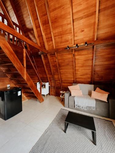 a living room with a couch and a table at Chalé Nosso Kadito - Glamping Estrada Real in Itutinga