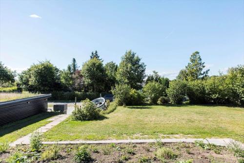 a garden with a car parked in the distance at 8217-Vordingborg-Kvaedevej-10 in Vordingborg