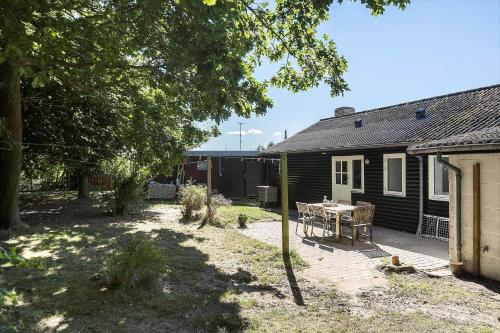 a backyard of a house with a table in front of it at 8217-Vordingborg-Kvaedevej-10 in Vordingborg