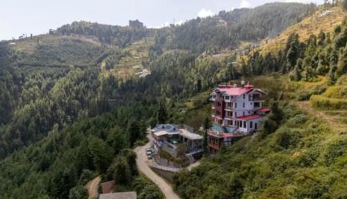 an aerial view of a house on a hill at The Mountain Palace Kufri By Exotic Stays in Kūfrī