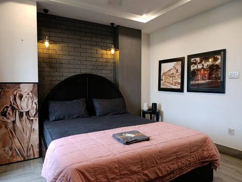 a bedroom with a bed and a brick wall at Brick Accent Loft 1BHK with Balcony & Free Netflix in Rawalpindi