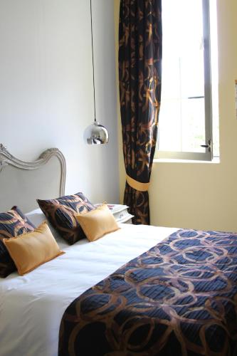 a bedroom with a bed and a window with curtains at Villa Toscane 2 in Marciac