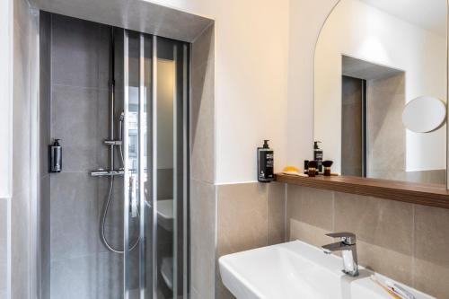 a bathroom with a shower and a sink and a mirror at Ibis Styles Paris Jardin de la Villette - Rénové en 2025 in Paris