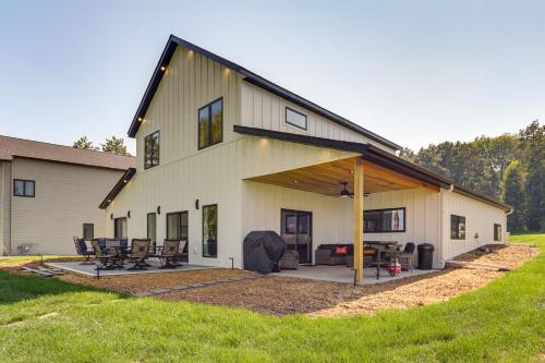 a large white house with a large patio at Lake Wapogasset Home with Dock 7 Mi to Amery in Amery