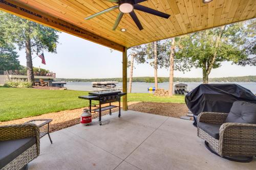 a patio with a ping pong table and chairs at Lake Wapogasset Home with Dock 7 Mi to Amery in Amery