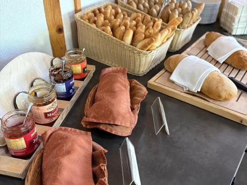 a table topped with trays of bread and pastries at Hotel Pieris in Vysoke Tatry - Podbanske