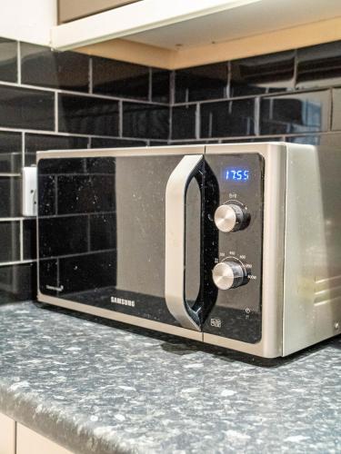 a microwave oven sitting on a counter in a kitchen at Bessemer House Sheffield in Sheffield